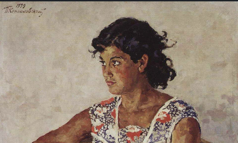 Brown-skinned Spanish woman in a floral dress sits on a plastic chair